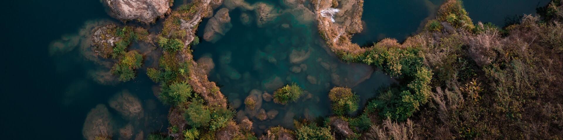 Aerial view of the cascading waters of Tamasopo River, where the river carves through the landscape creating a mesmerizing mosaic of turquoise pools, San Luis Potosi, San Luis Potosi, Mexico.