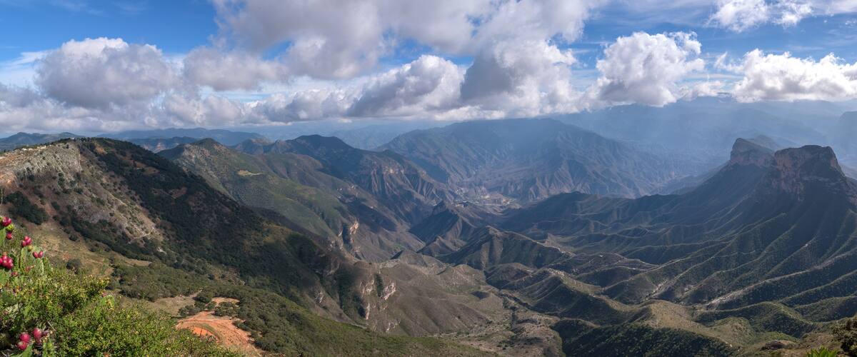 A mountainous landscape with rugged terrain and a clear sky.
