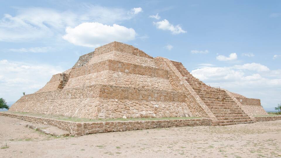 A large stone pyramid with a stepped structure.