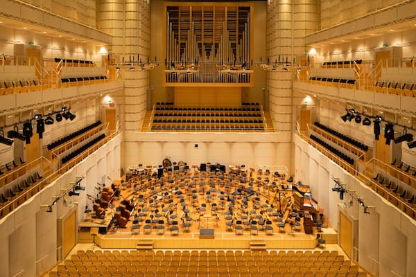 A large concert hall with tiered seating and a stage for orchestras.