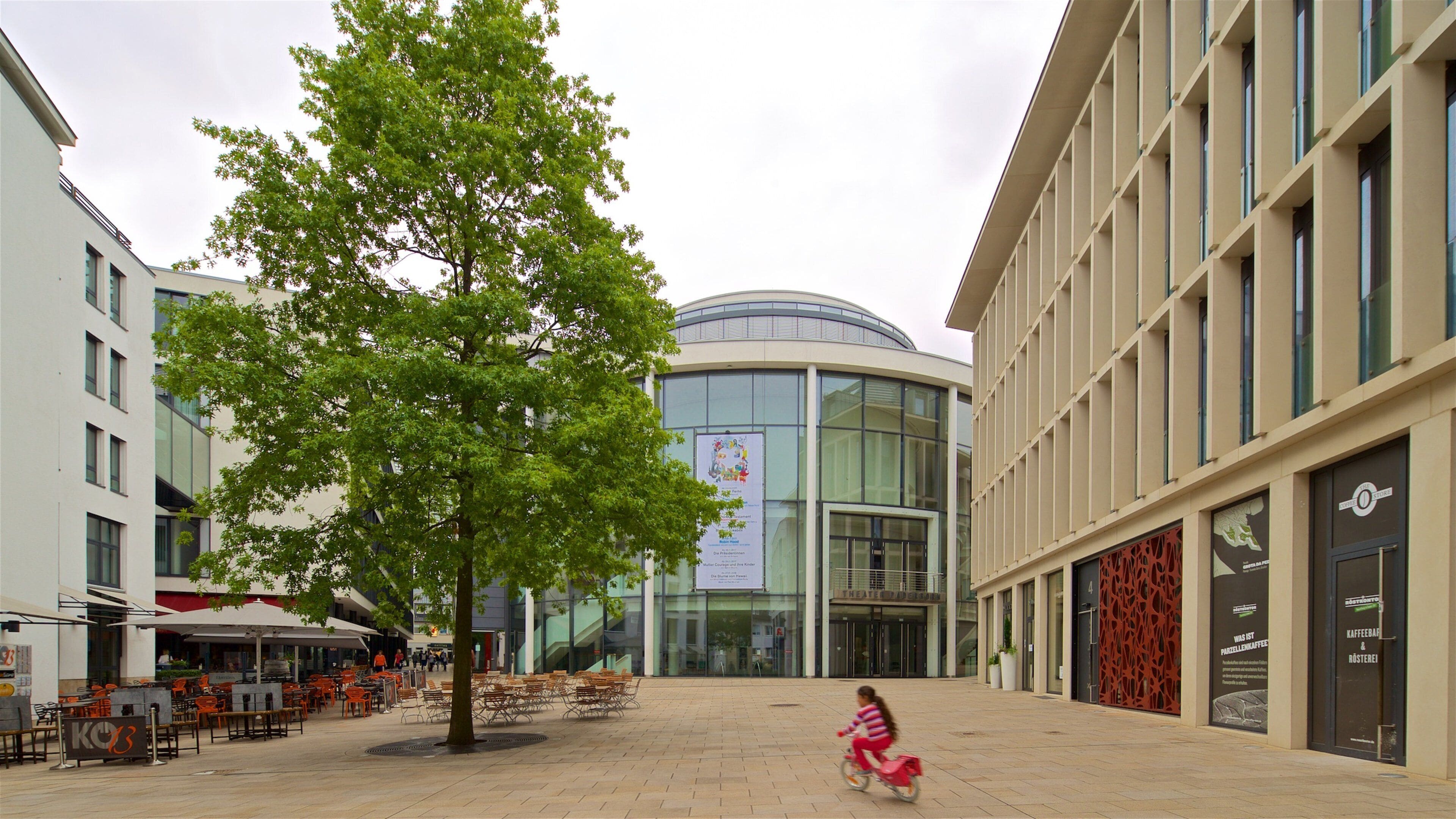 Theater Paderborn featuring modern architecture, street scenes and cycling