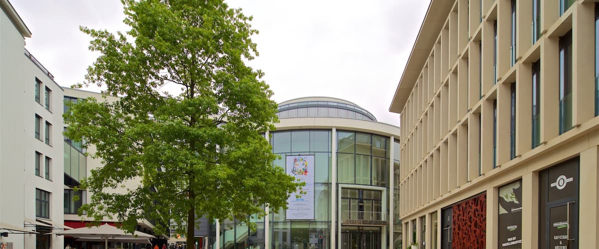 Theater Paderborn featuring modern architecture, street scenes and cycling