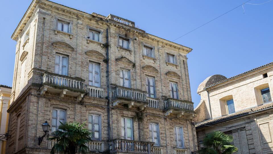 A historic building with multiple balconies and arched windows.