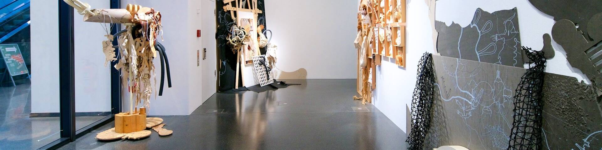 An art gallery with various sculptures and installations.