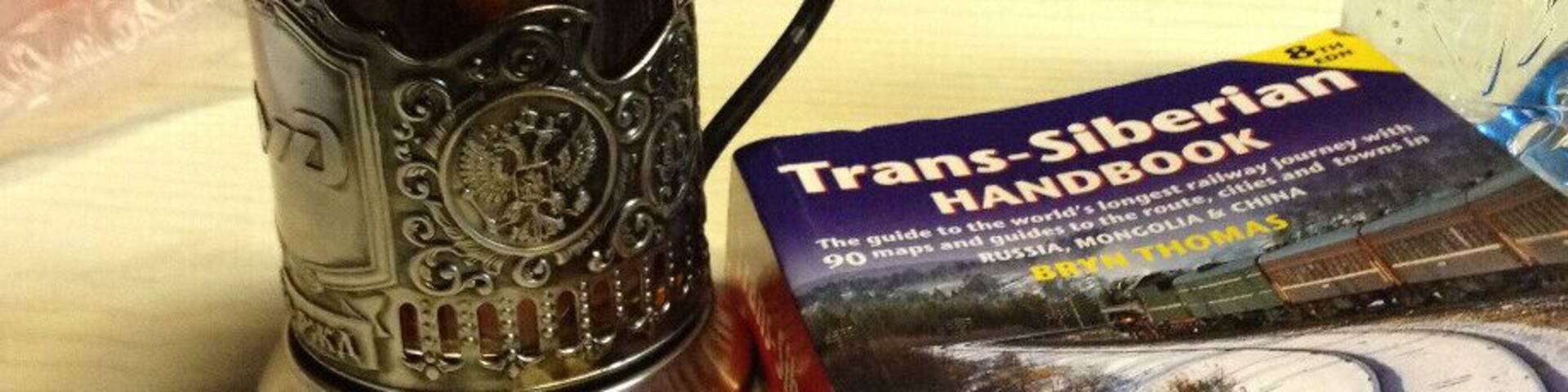 We took the Trans-Siberian train from Moscow to St Petersburg, 8 hours ride in 3rd class (platzkart) and we didn't regret it at all. We slept very well, the provodnitsa was really kind, but don't expect to find a lot of English speakers there. Body language does wonders :).
This is the cup they use for serving tea, i especially liked the metal cup holder, which was beautifully crafted. You can also buy one from the train, I think it was around 800 RUB. And it seemed only appropriate to read the Trans-Siberian Handbook on the way. Dreaming of doing the whole thing from Moscow to Vladivostok one day!