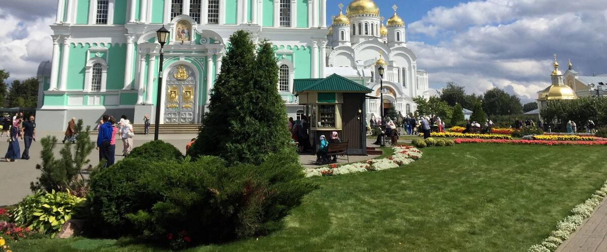 A large church with multiple domes and a green facade.