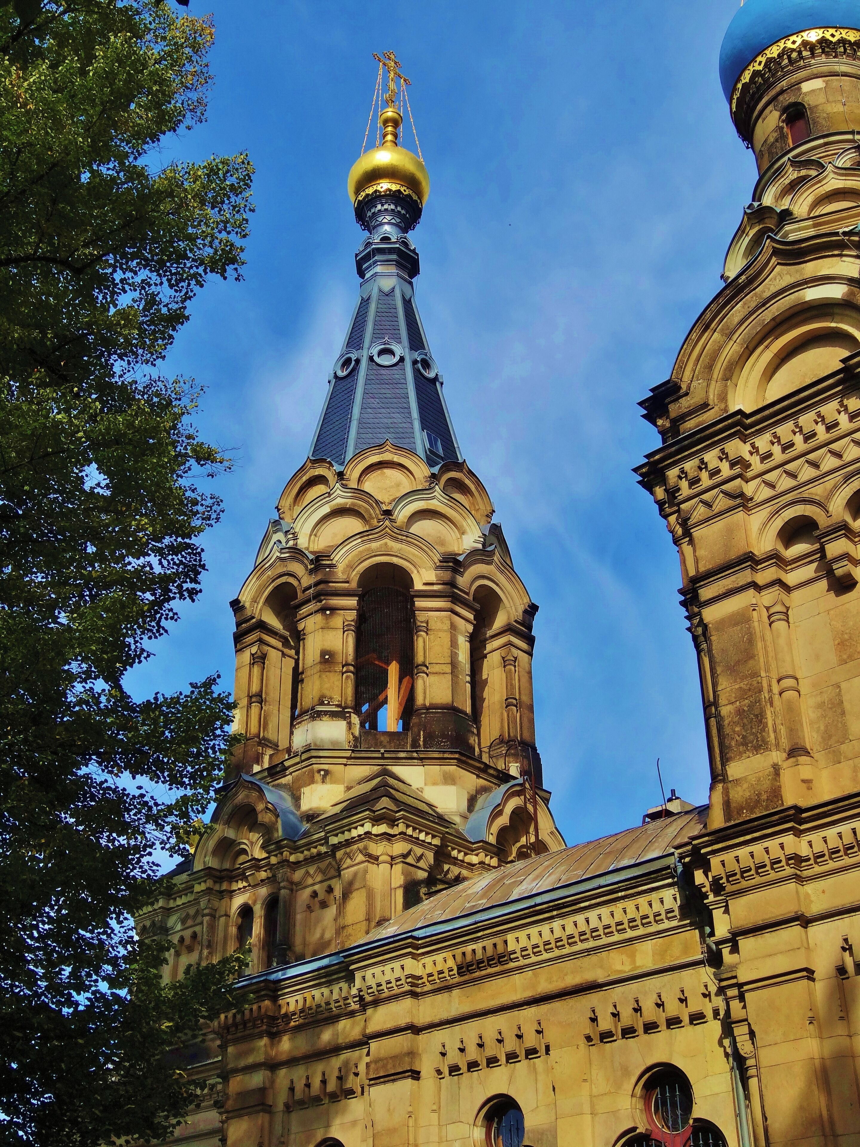 A church with a golden dome and a tall spire.