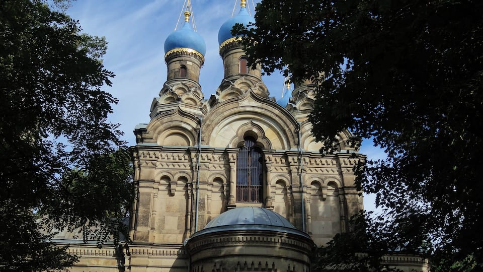 A historic church with ornate architecture, including domes and a central bell tower.
