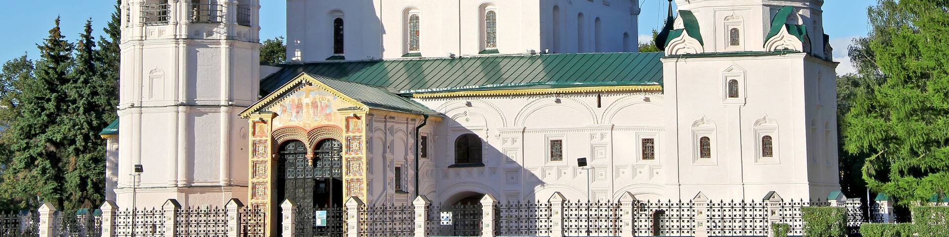 A church with multiple domes and crosses, surrounded by a fence.
