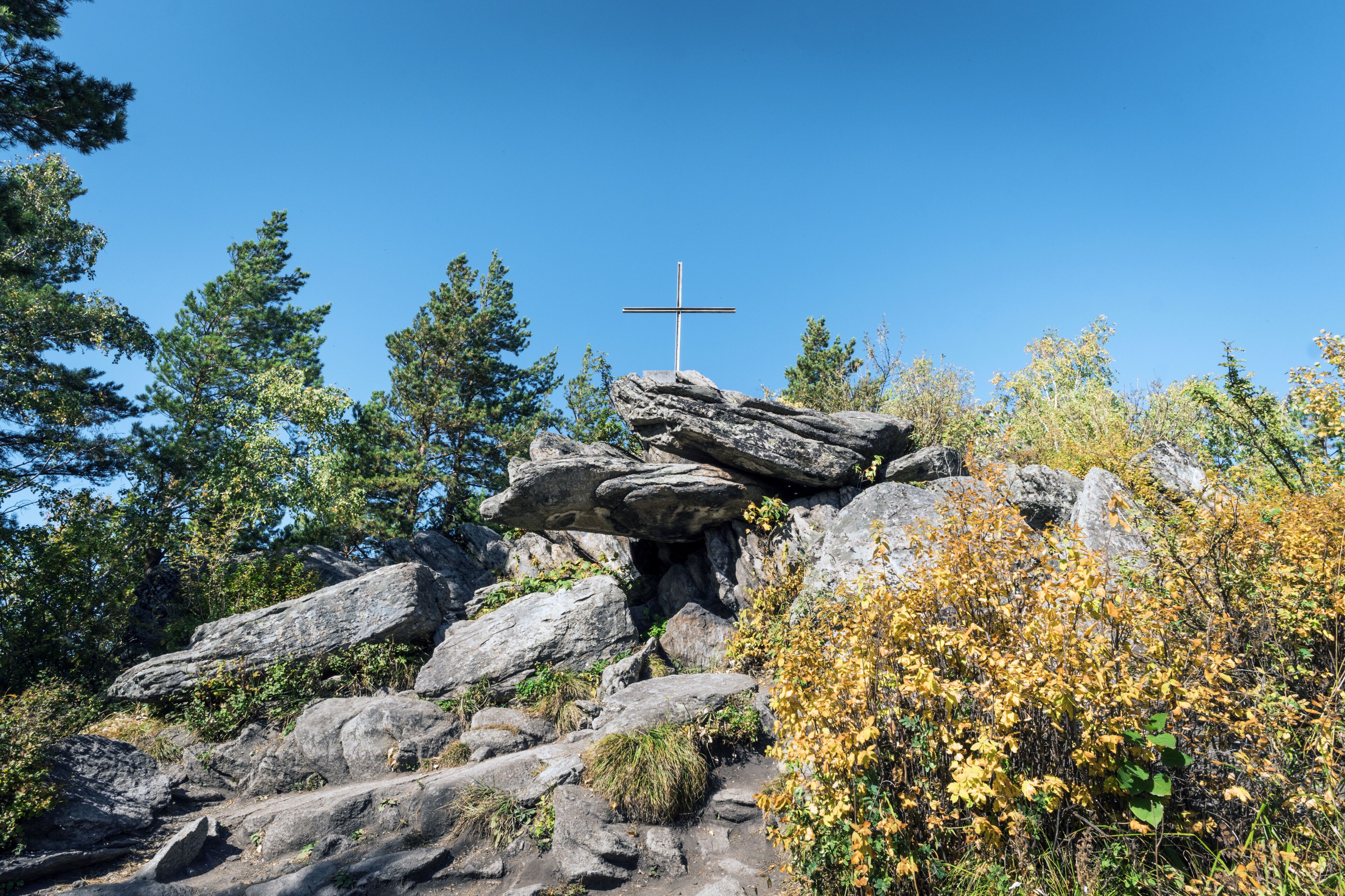 Bizarre rock with an Orthodox cross. Church mountain. Belokurikha resort Russia.