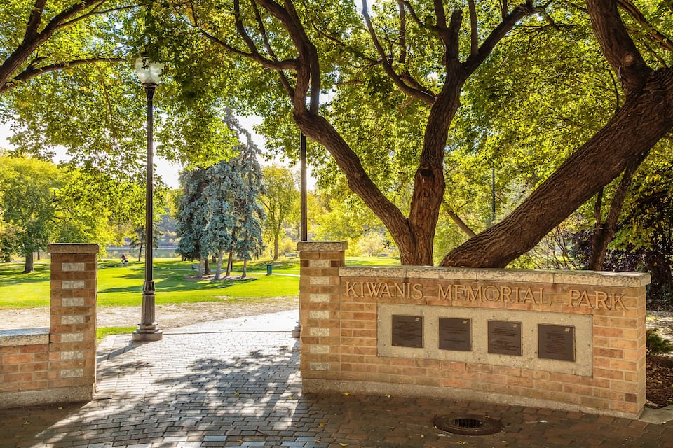 Un muro de ladrillo con la inscripción "KIWANIS MEMORIAL PARK" y tres placas.