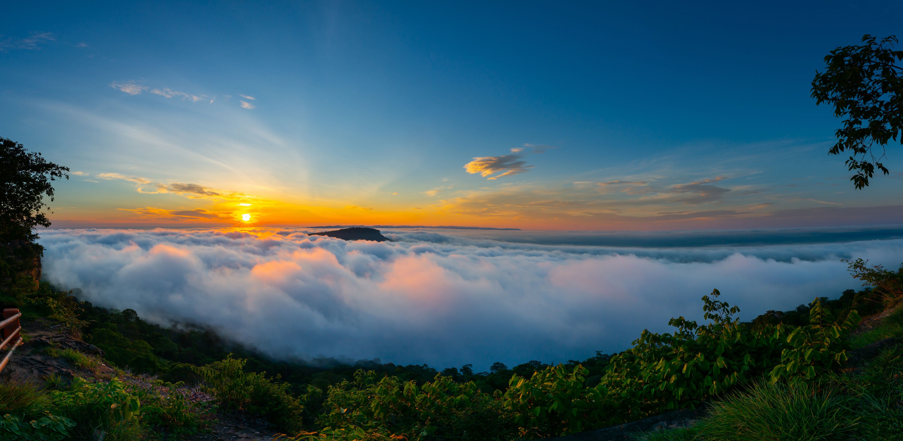 Panorama Beautiful Clouds and fog above mountain, beautiful morning sunshine landscape at Pha Mo i Daeng Phra Wihan National Park. Sisaket province,Thailand,ASIA.
