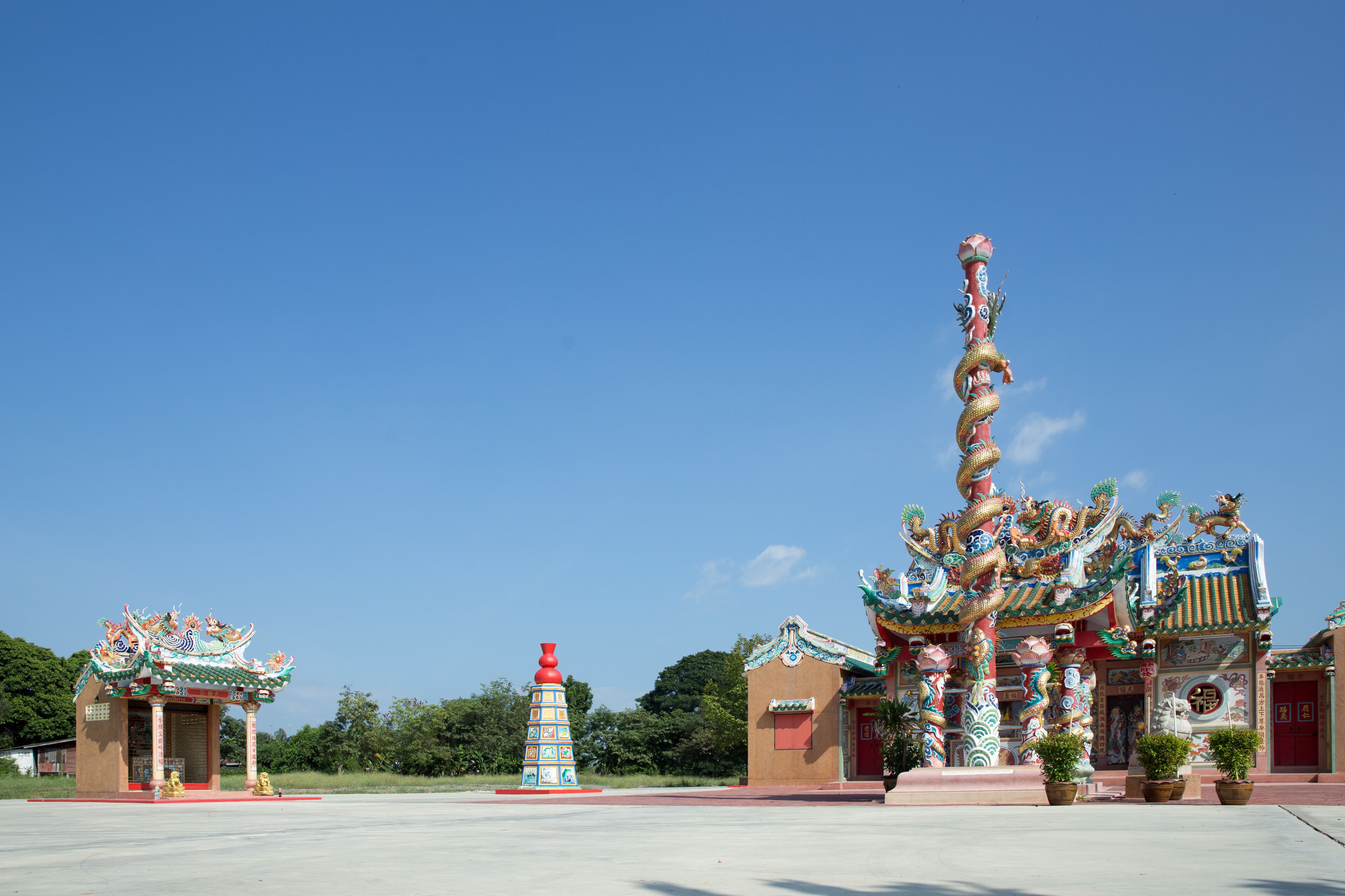 A traditional Chinese temple with ornate architecture and a dragon statue.