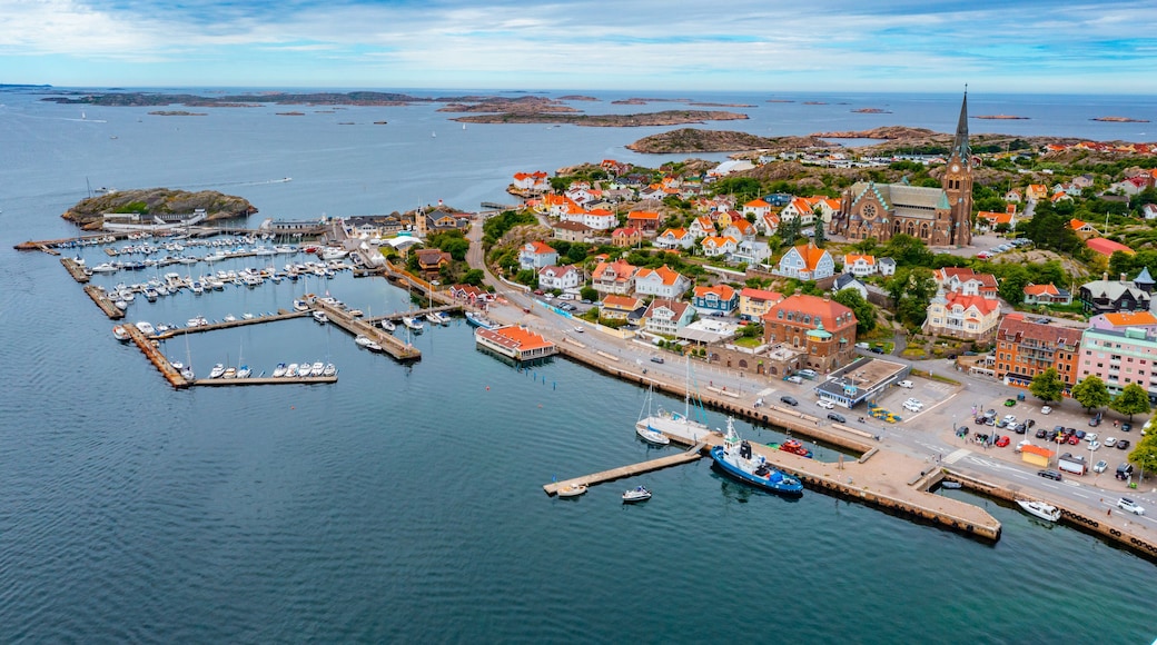 A coastal town with a prominent church, marina, and colorful houses.