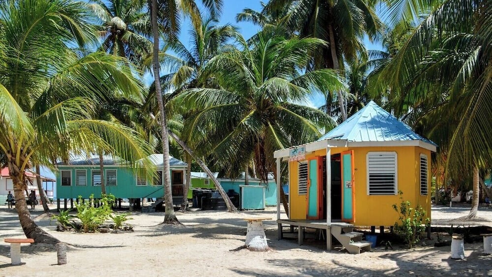 Tobacco Caye is a tiny bit of coral and sand anchored along Belize's barrier reef. The island is packed with bare-bones backpacker accommodations, and, judging by the number of beer bottles, sees lots of partying.