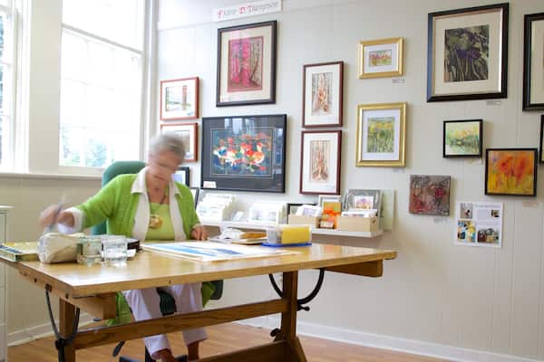 The Old School House Arts Centre featuring interior views and art as well as an individual femail