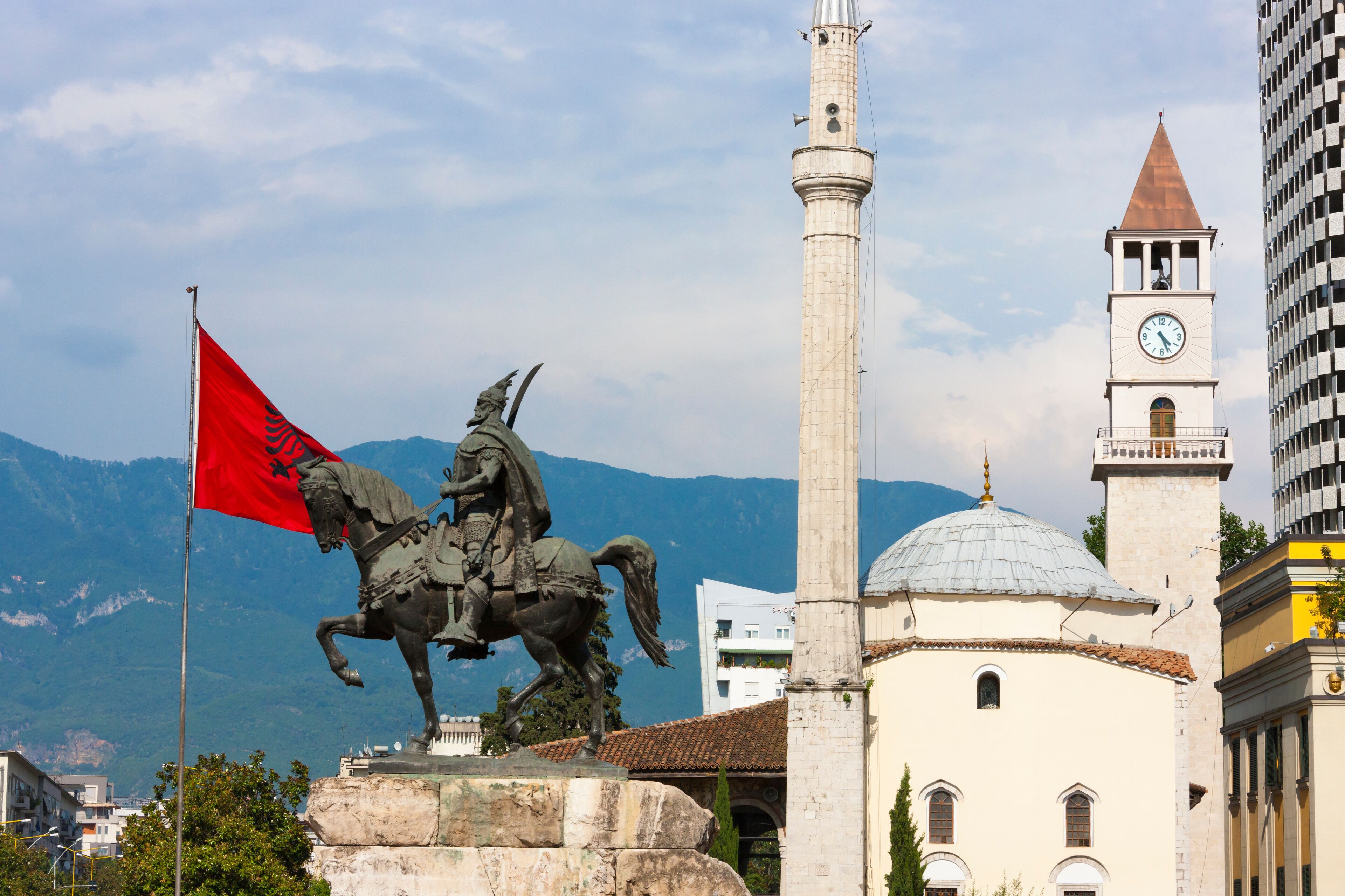 Statue of Et'hem Bey Mosque and Clock Tower, Coin Shopping Center housing the Italian Department Store in Skanderbeg Square, Tirana, Albania