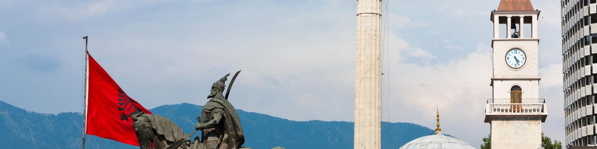 Statue of Et'hem Bey Mosque and Clock Tower, Coin Shopping Center housing the Italian Department Store in Skanderbeg Square, Tirana, Albania