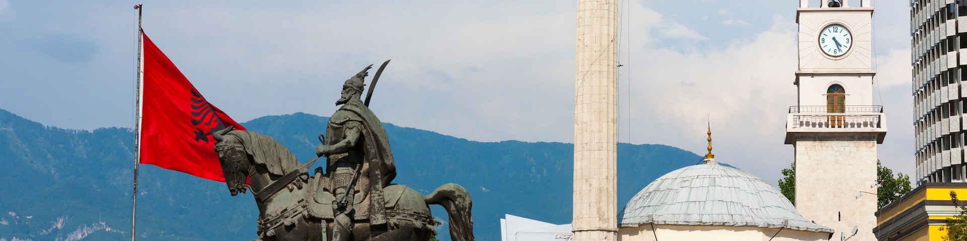 Statue of Et'hem Bey Mosque and Clock Tower, Coin Shopping Center housing the Italian Department Store in Skanderbeg Square, Tirana, Albania