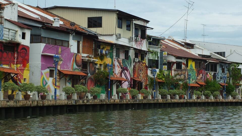 Bright graffiti walls seen from Malacca river