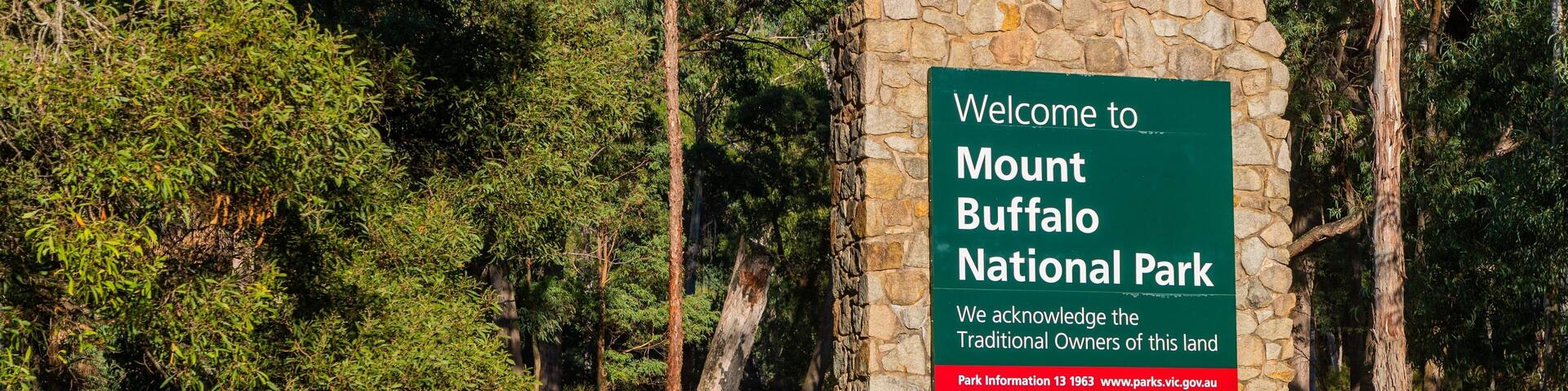 A sign welcoming visitors to Mount Buffalo National Park, acknowledging traditional landowners, and providing park information.