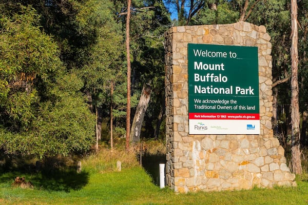 A sign welcoming visitors to Mount Buffalo National Park, acknowledging traditional landowners, and providing park information.