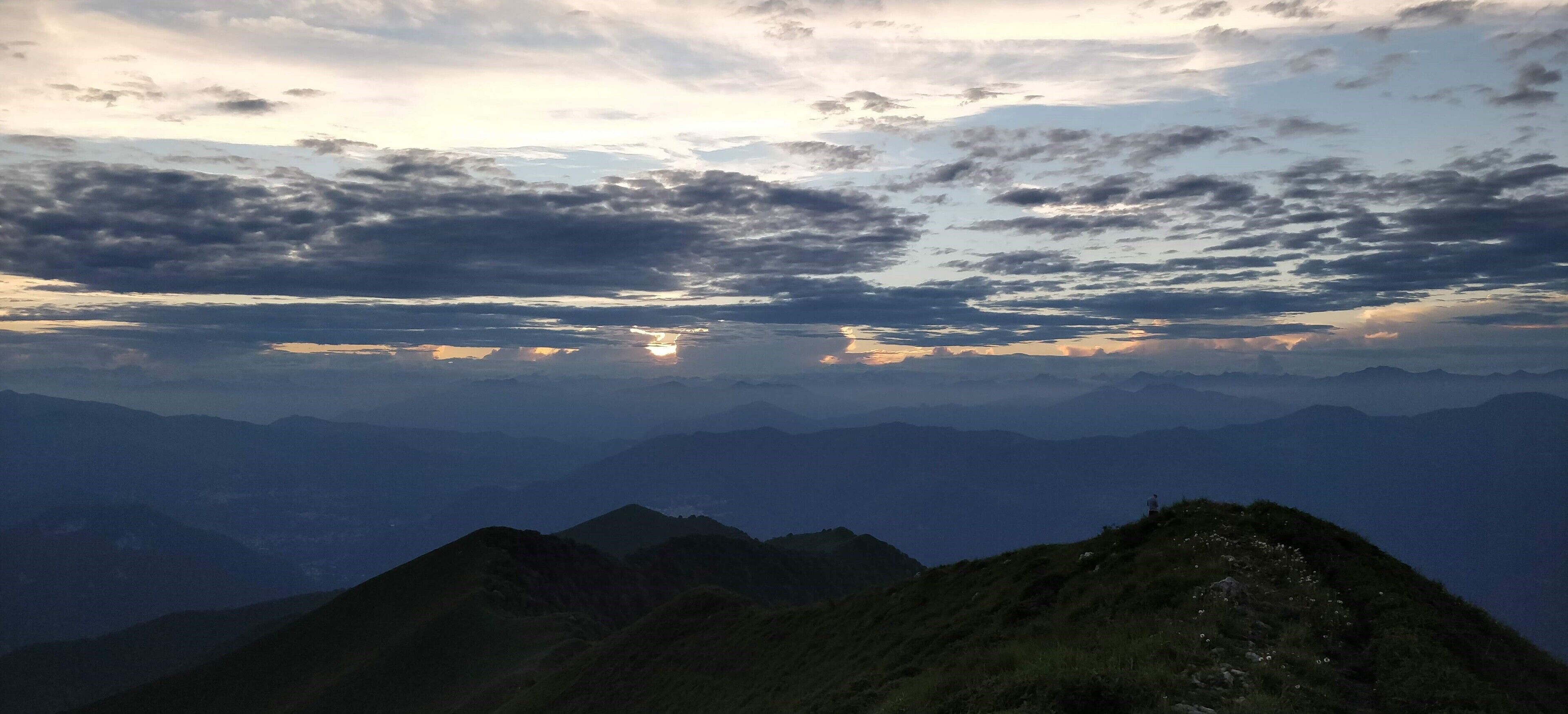 A mountain range with a cloudy sky.