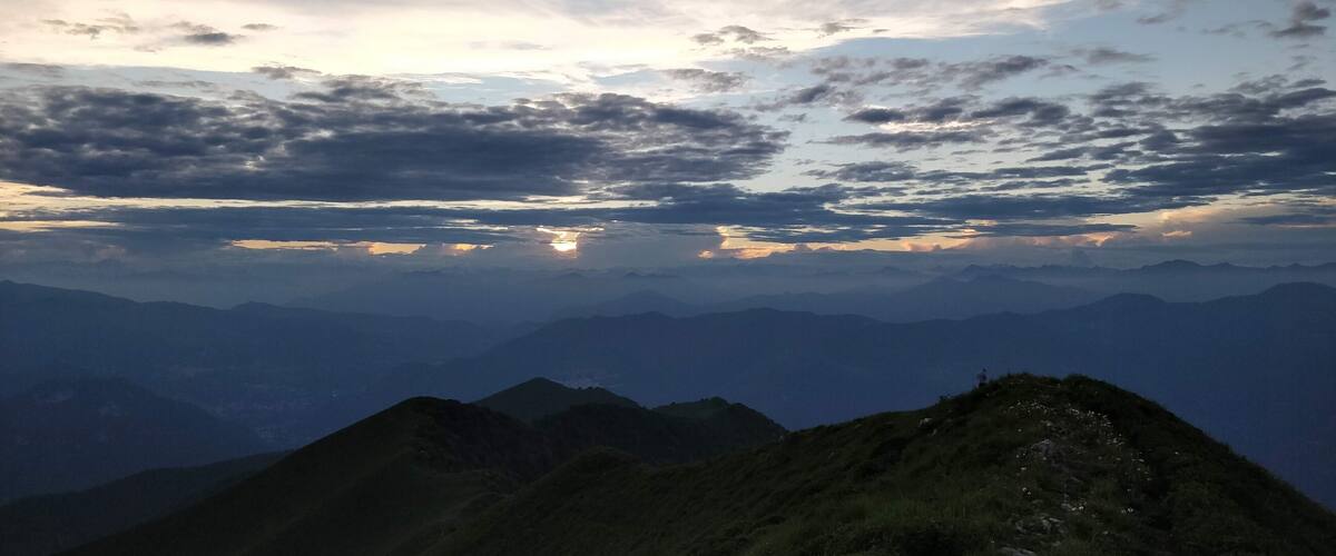 A mountain range with a cloudy sky.