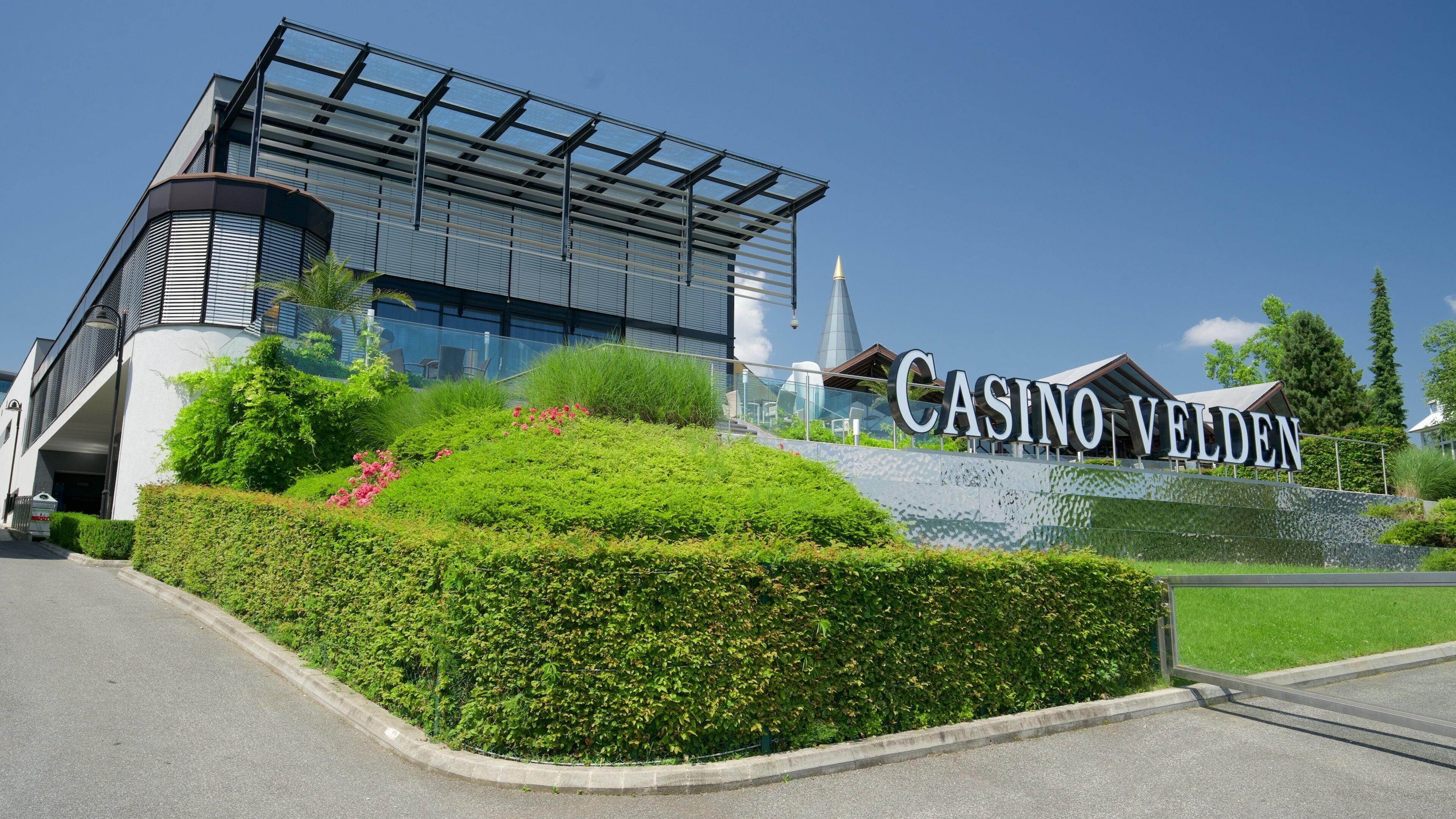 Casino Velden featuring signage and a garden