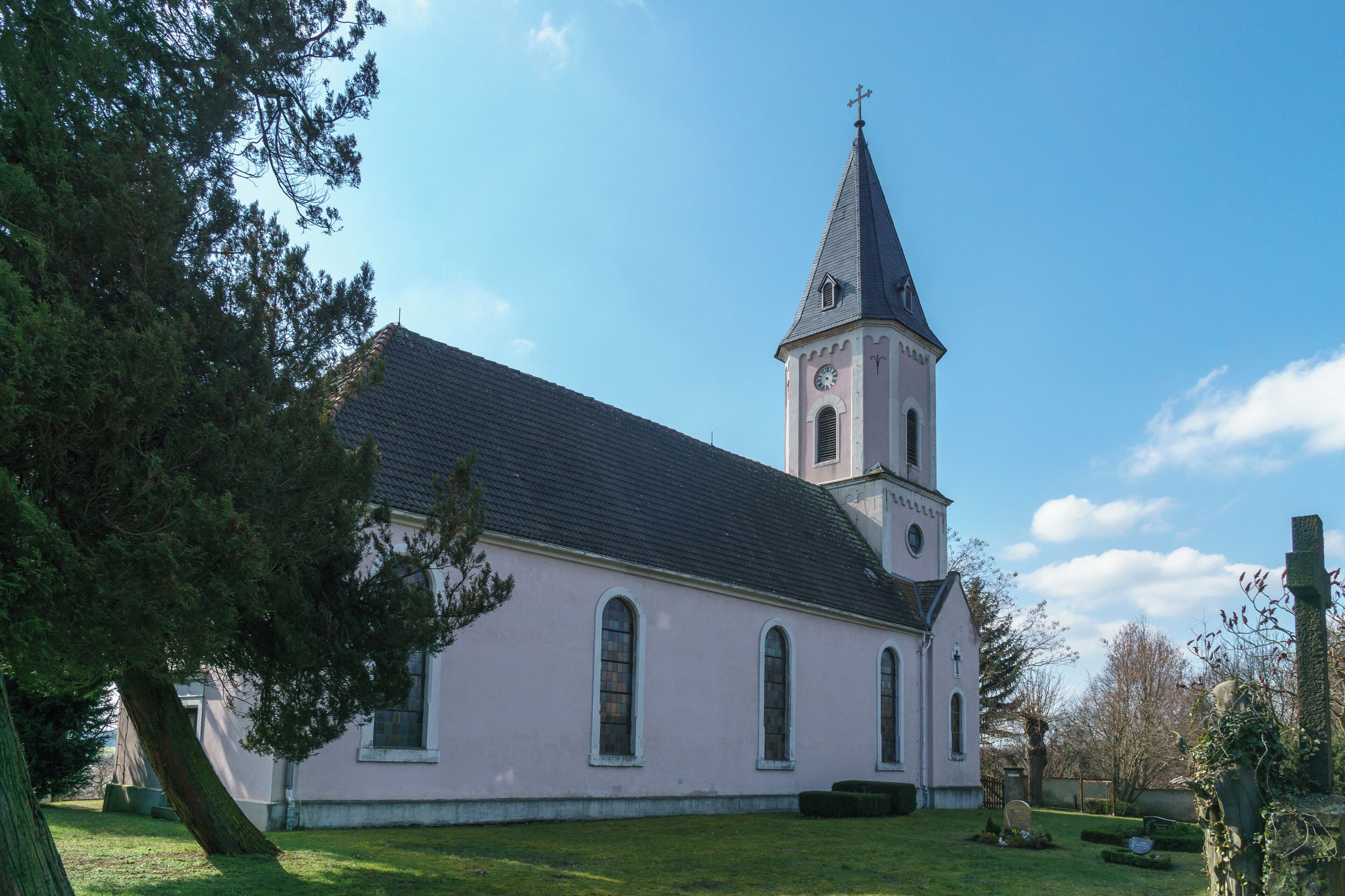 A church with a tall steeple and a clock tower.