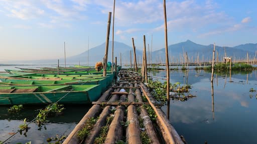 Fishing boats on the shores of Rawa Pening lake. Beautiful view of Rawa Pening lake and the Merbabu and Telomoyo mountains. Fishermen at Rawa Pening lake.