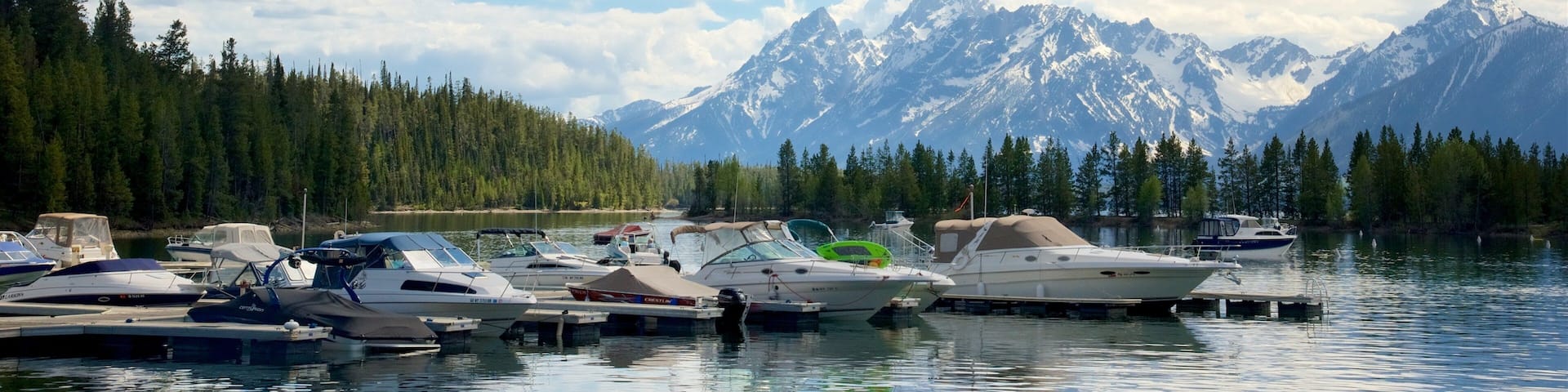 Colter Bay Visitor Center which includes a river or creek and mountains