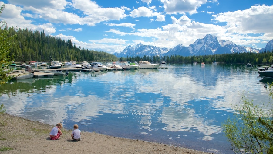 Colter Bay Visitor Center which includes a lake or waterhole and a bay or harbor as well as children