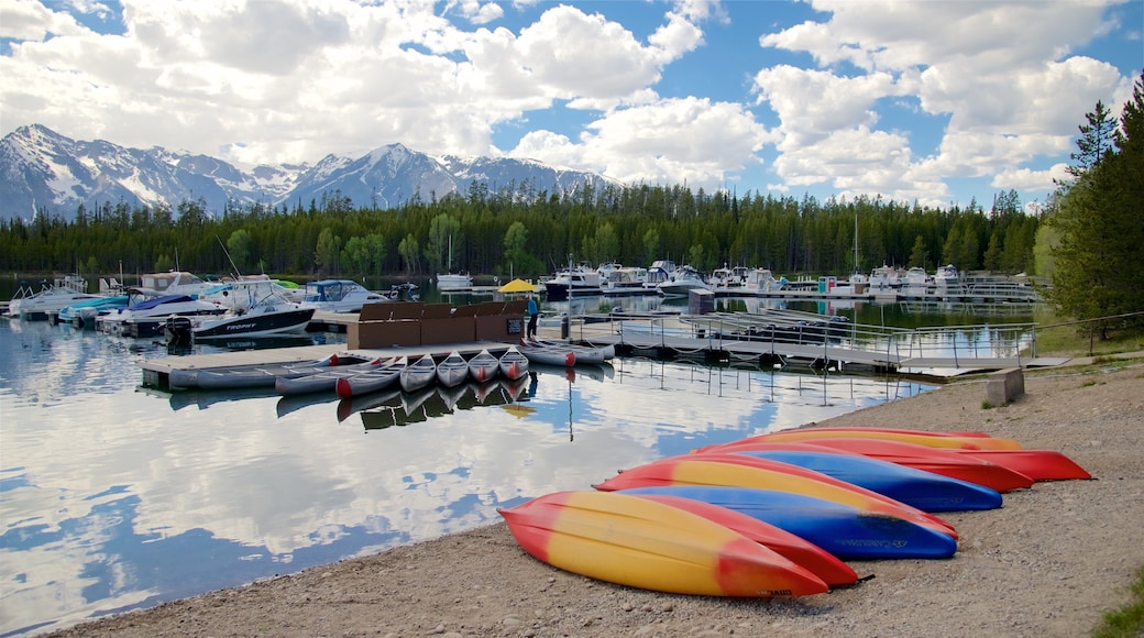 Colter Bay Visitor Center featuring a bay or harbor, mountains and a lake or waterhole