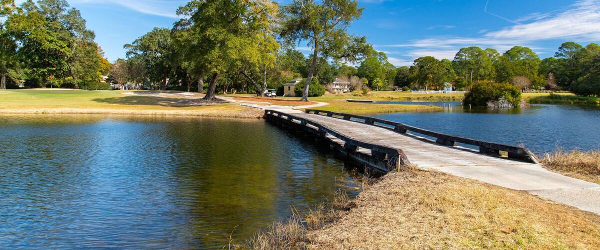 Bluewater Bay Golf Course showing a bridge and a pond
