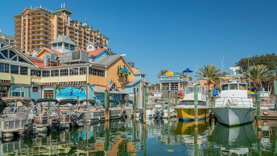 A marina with boats docked, a large building with a mural, and a sign for Margaritaville.