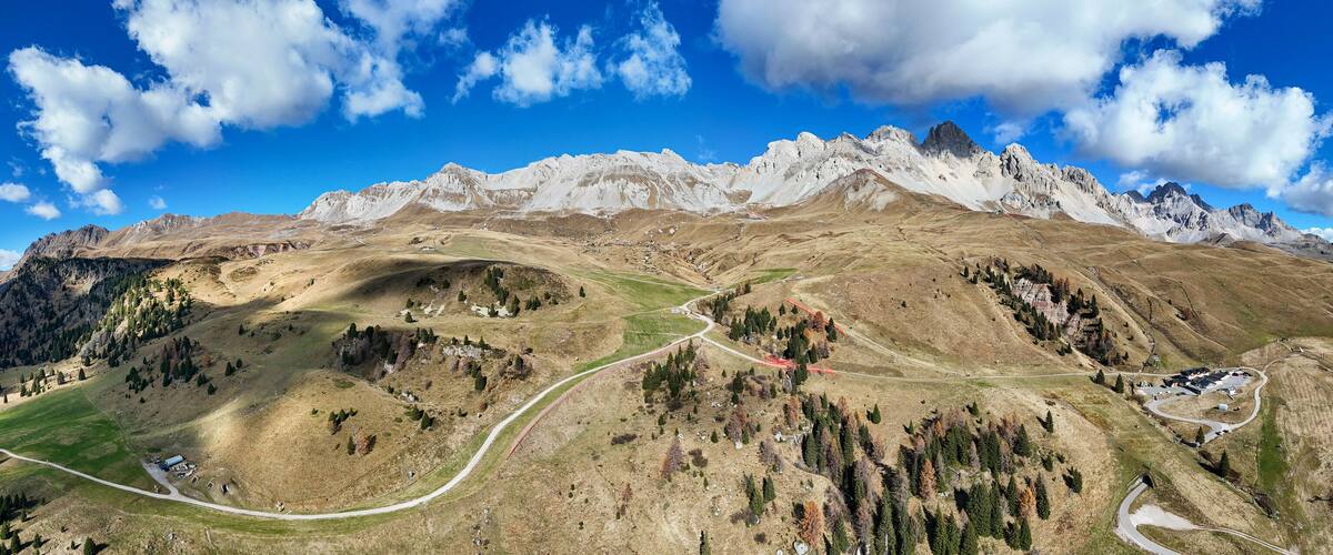 Aerial view of majestic mountain landscape with panoramic view of Dolomites and pass road, Passo San Pellegrino, Moena, Italy.