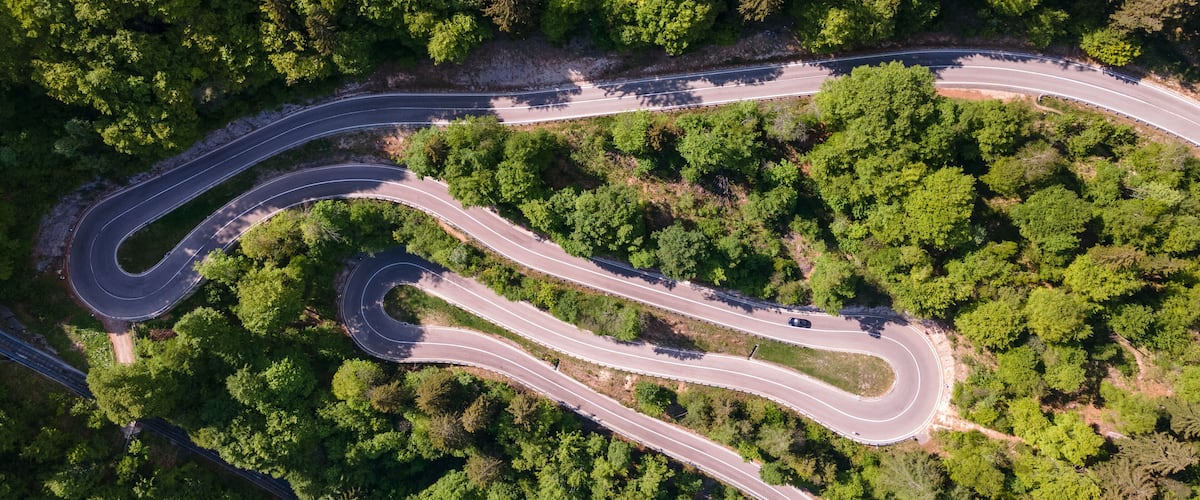 A winding road through a dense forest.