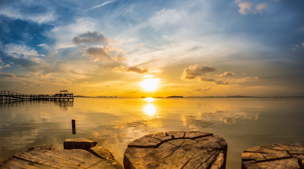 Horizon over the water. Calm songkhla lake with sunset sky and sun through the clouds over. Meditation lake and sky background at Sathing Phra, Songkhla, Thailand