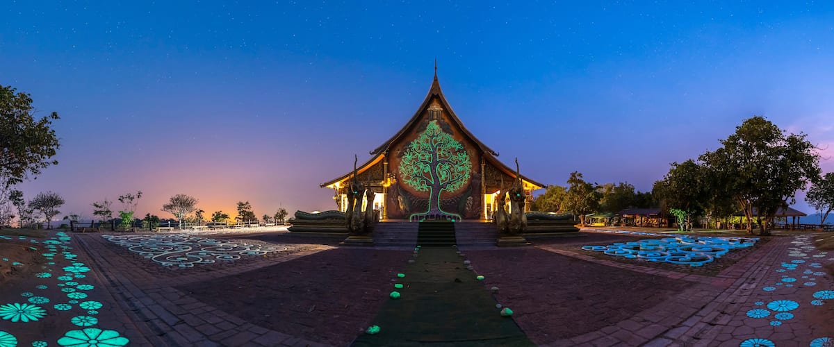 A traditional temple with intricate carvings and a starry night sky.