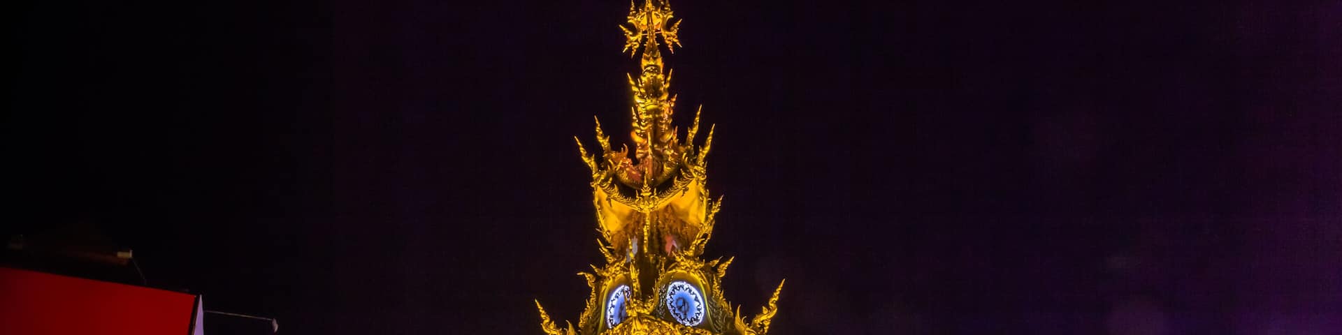 sunset at clock tower in Chiang Rai town. beautiful sculpture clock tower in central of Chiang Rai city.the color of clock tower start to change in twilight