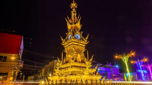 sunset at clock tower in Chiang Rai town. beautiful sculpture clock tower in central of Chiang Rai city.the color of clock tower start to change in twilight