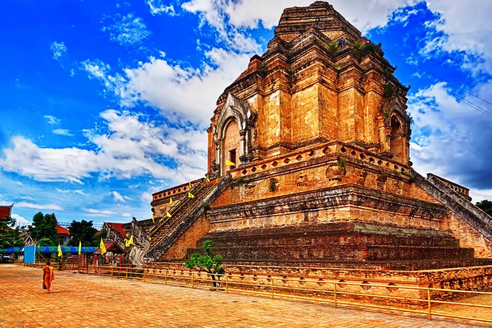 A large, ancient temple with a steep staircase and a large central tower.