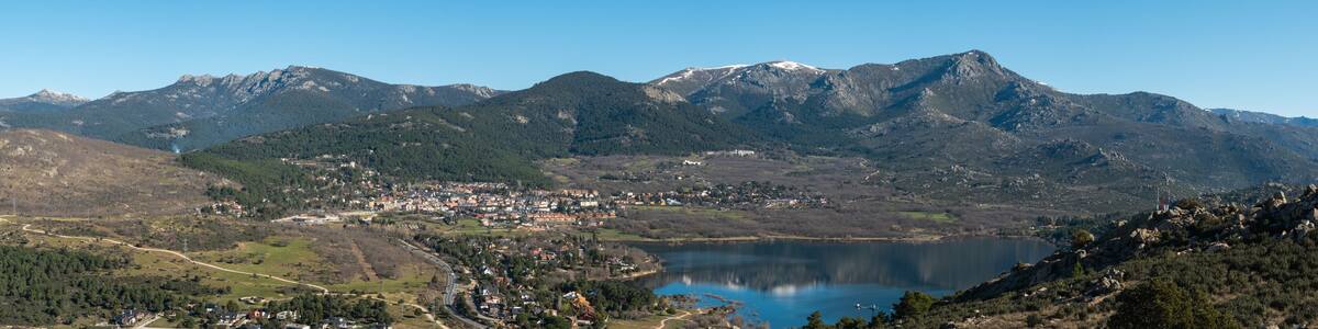 Panoramic view of the lake and the village of Navacerrada in the Community of Madrid with the Sierra de Guadarrama in the background - Siete Picos - Bola del Mundo - La Maliciosa