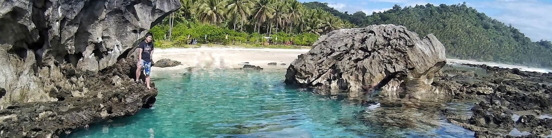 The Tibu Tidal Pool in San Ildefonso, Casiguran Aurora Philippines. Amazing rock formations, crystal clear water, and white sand stunning long coastline.