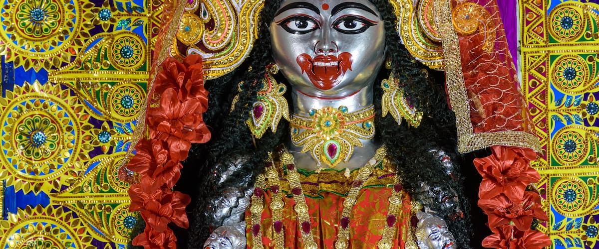 A colorful, intricately decorated statue with elaborate patterns and jewelry.