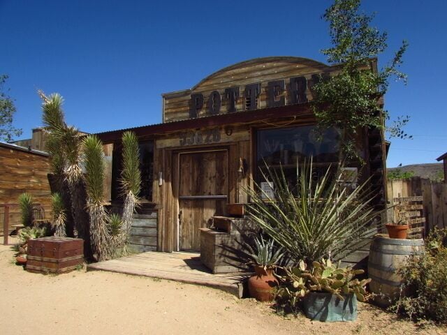 A rustic building with a wooden facade and the sign 'POTTER'.