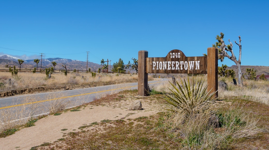Pioneertown California welcome sign next to a paved road