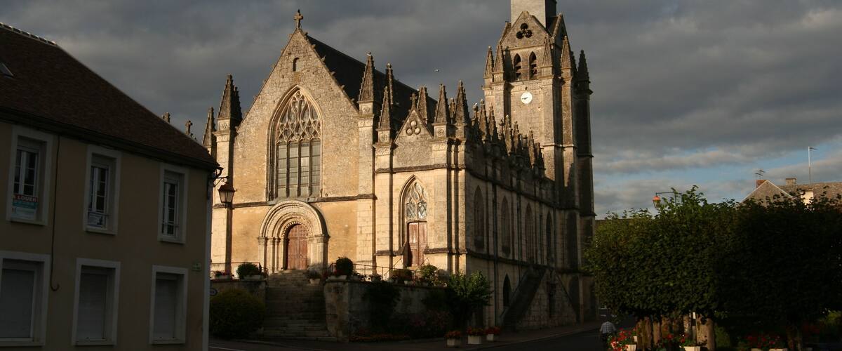 A historic church with a tall spire and a clock tower.