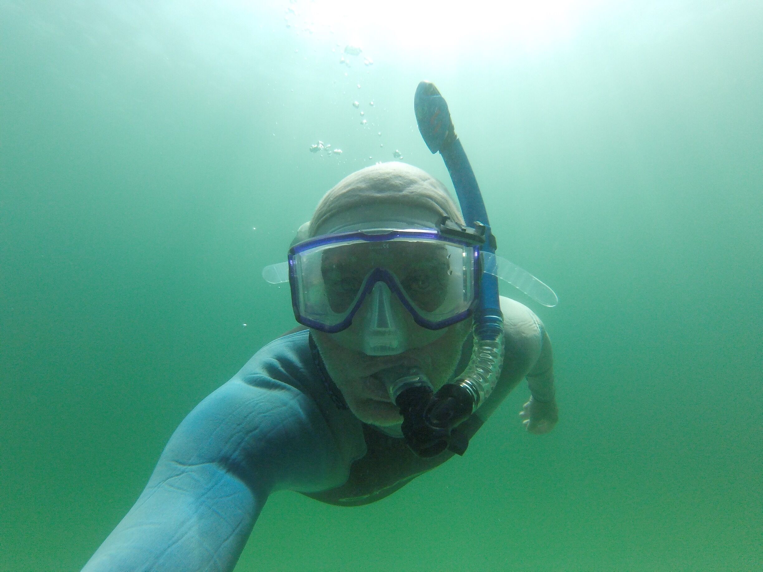 A person snorkeling underwater.